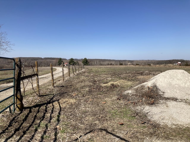 view of yard with a rural view and fence