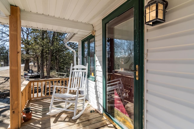 wooden terrace featuring covered porch