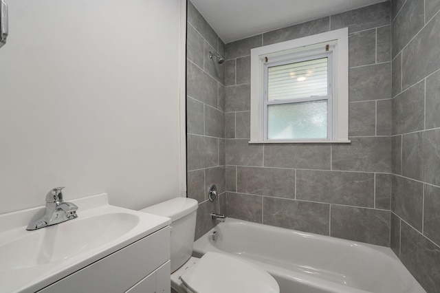 bathroom featuring  shower combination, vanity, and toilet