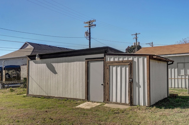 view of outbuilding with fence and an outdoor structure