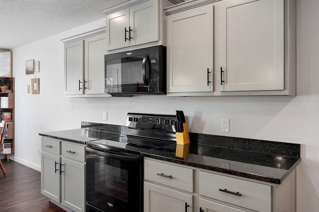 kitchen with black appliances, baseboards, dark stone counters, and dark wood-style flooring
