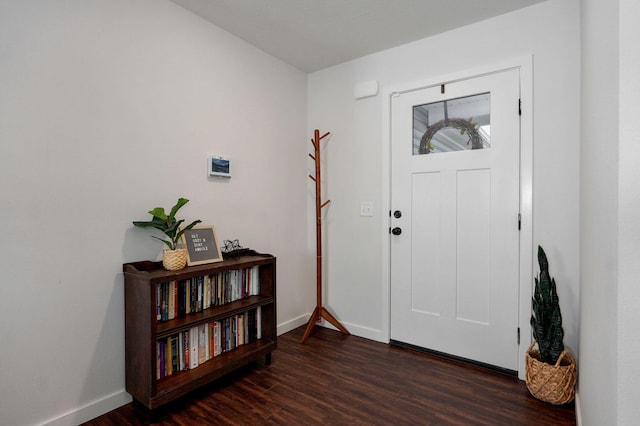 entryway with wood finished floors and baseboards