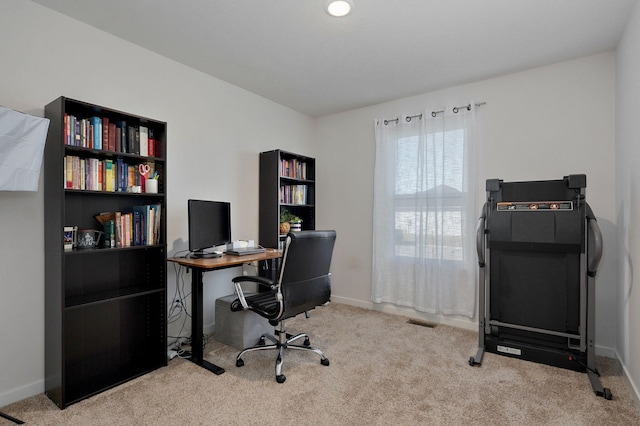 carpeted office featuring visible vents and baseboards