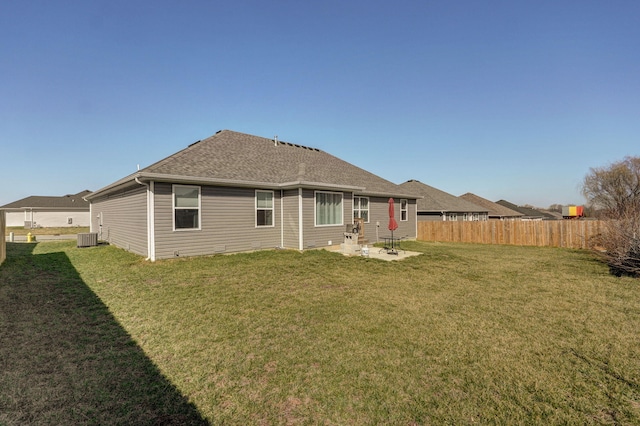 rear view of property featuring a yard, fence, a patio, and central AC unit