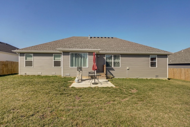 rear view of house with a yard, a shingled roof, a patio, and fence private yard