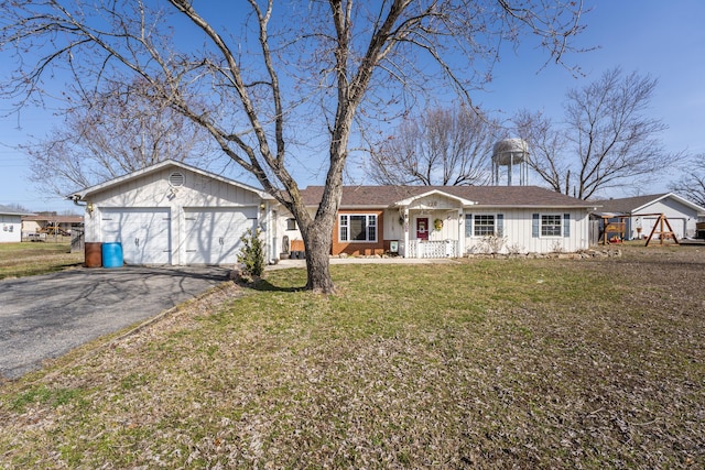 ranch-style house with aphalt driveway, a front lawn, and an attached garage