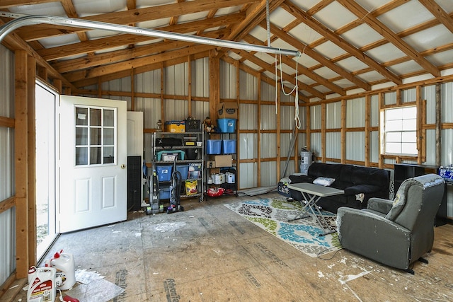 interior space featuring metal wall, a garage, and vaulted ceiling