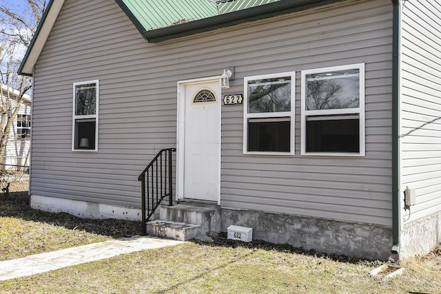 view of exterior entry featuring metal roof
