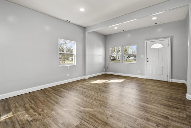 entrance foyer featuring a wealth of natural light, visible vents, wood finished floors, and baseboards