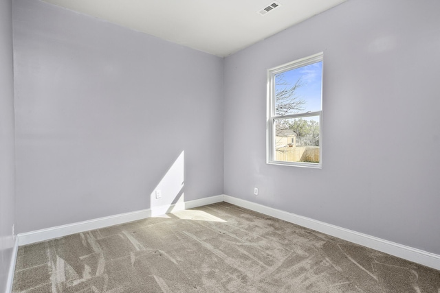 carpeted empty room with baseboards and visible vents