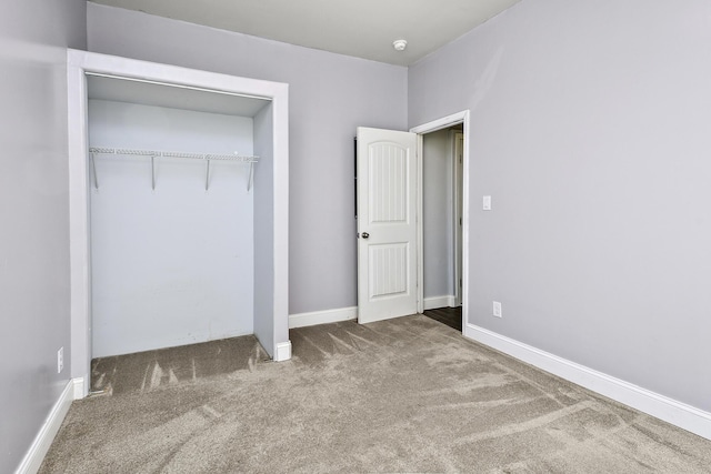 unfurnished bedroom with baseboards, a closet, and carpet
