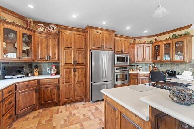 kitchen with brown cabinetry, decorative backsplash, stainless steel appliances, and light countertops