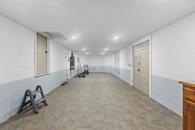 exercise room featuring recessed lighting and concrete block wall