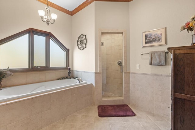 bathroom featuring tile patterned flooring, ornamental molding, a bath, and a shower stall