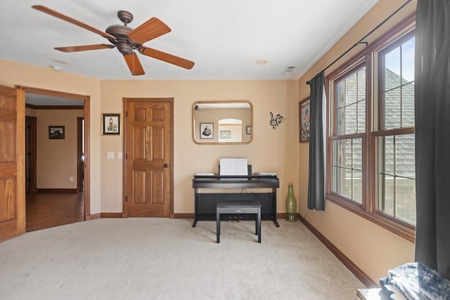 sitting room with a healthy amount of sunlight, baseboards, visible vents, and carpet floors