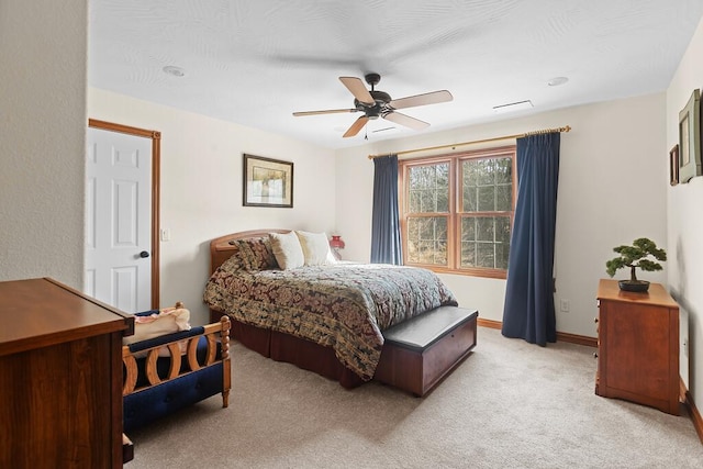 bedroom with ceiling fan, visible vents, baseboards, and light colored carpet