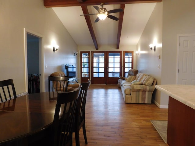 dining room featuring high vaulted ceiling, wood finished floors, baseboards, french doors, and beam ceiling