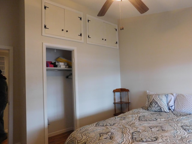 bedroom featuring ceiling fan, a closet, and dark wood finished floors