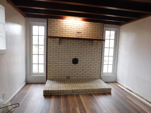 bathroom with a wealth of natural light, beamed ceiling, and wood finished floors