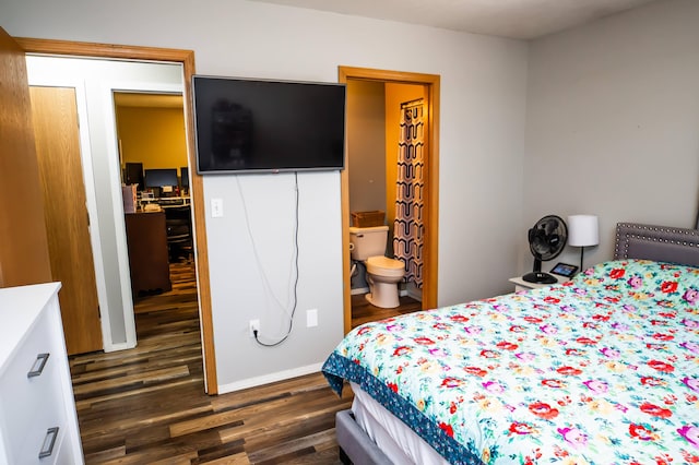 bedroom with dark wood-style floors and connected bathroom