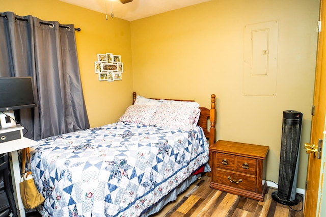 bedroom featuring wood finished floors and electric panel