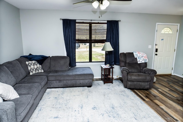 living area with ceiling fan, baseboards, and wood finished floors