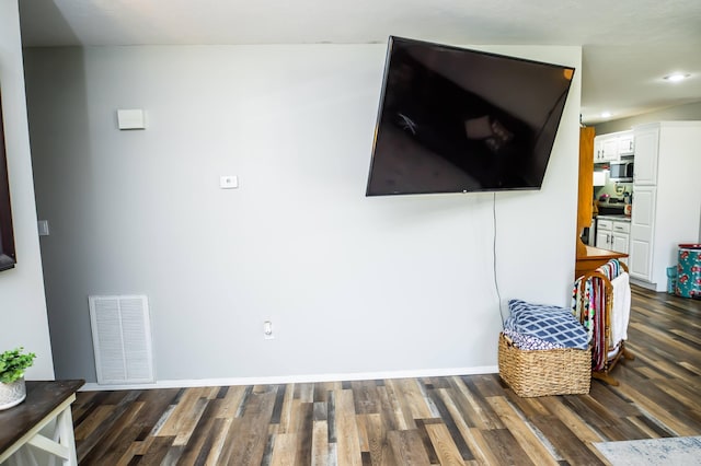 living room featuring baseboards, visible vents, and dark wood finished floors