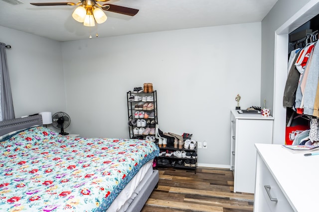 bedroom featuring a ceiling fan, visible vents, and dark wood-style flooring