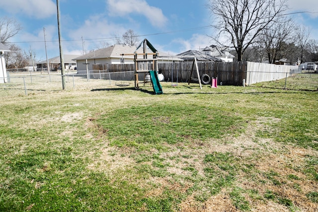 view of yard featuring a playground and a fenced backyard