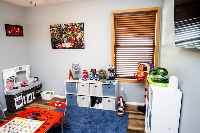 game room featuring baseboards and wood finished floors