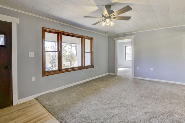 unfurnished room featuring crown molding, baseboards, and ceiling fan