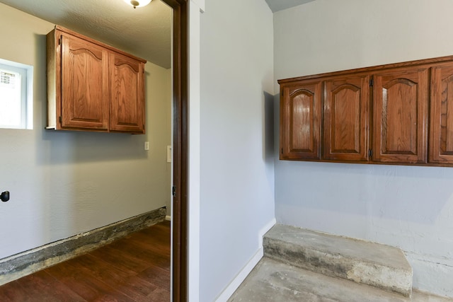 interior space featuring baseboards and wood finished floors