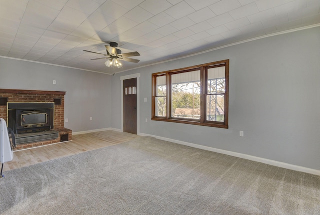 unfurnished living room featuring ornamental molding, carpet, ceiling fan, and baseboards