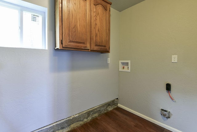 laundry room featuring washer hookup, dark wood finished floors, cabinet space, and baseboards