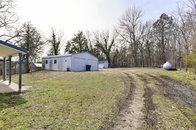 exterior space featuring a garage, an outbuilding, and fence