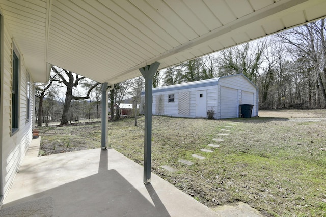 view of patio with a garage and an outdoor structure