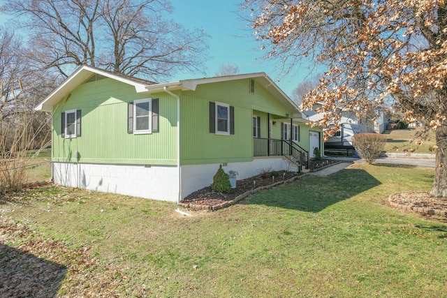 view of side of property featuring crawl space and a lawn