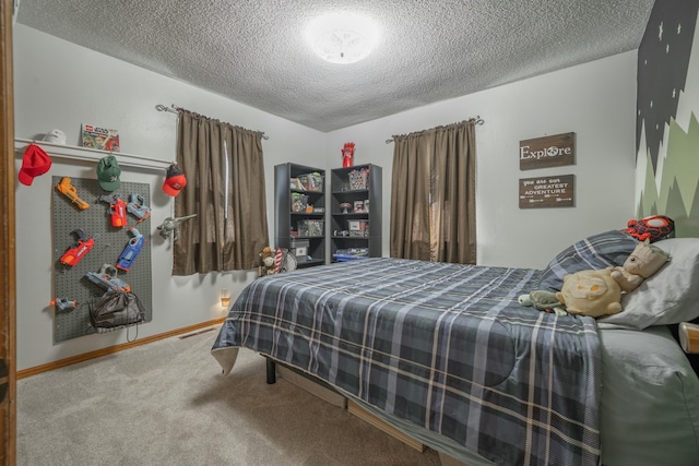 carpeted bedroom with a textured ceiling and baseboards