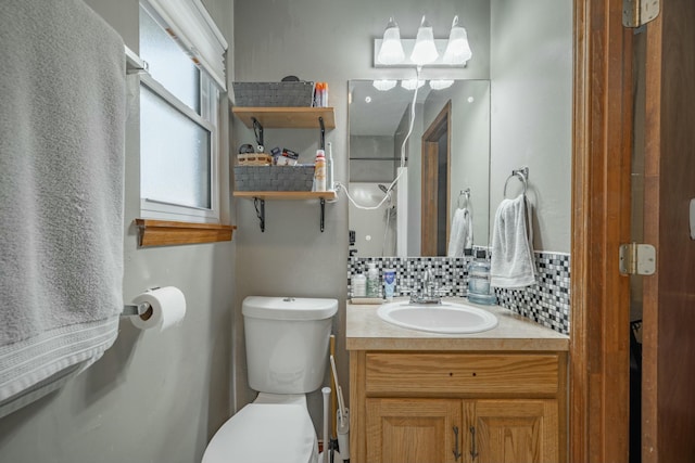 bathroom with toilet, tasteful backsplash, and vanity