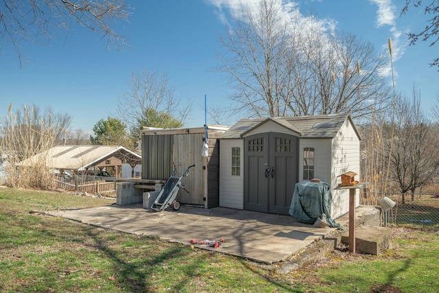 view of shed featuring fence