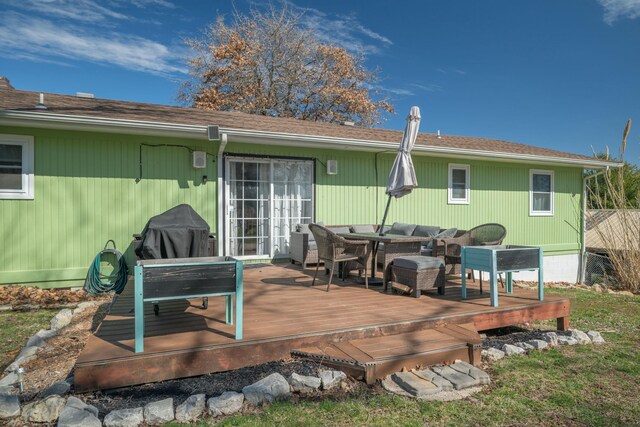 back of property featuring a deck and outdoor dining space