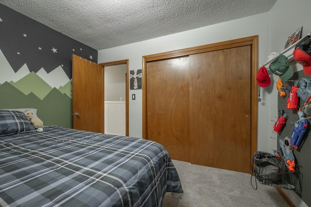 bedroom with a textured ceiling, a closet, and carpet