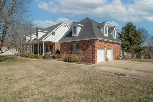 view of side of property featuring a garage, concrete driveway, a lawn, roof with shingles, and brick siding