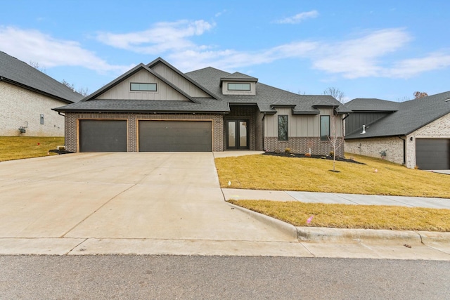 view of front of home with a garage, concrete driveway, roof with shingles, a front lawn, and board and batten siding