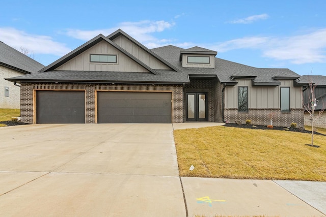 view of front of house featuring driveway, brick siding, a front lawn, and roof with shingles