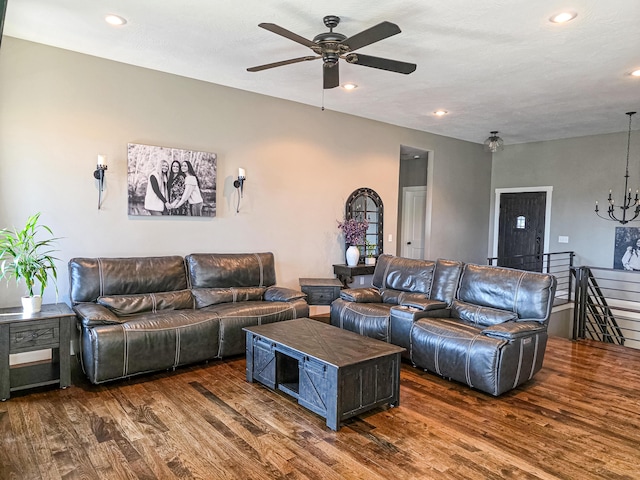 living room with ceiling fan with notable chandelier, recessed lighting, and wood finished floors