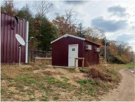 view of shed featuring fence