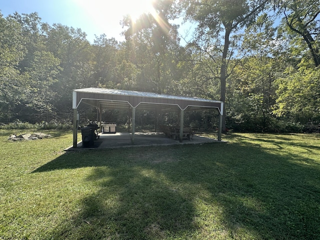 view of yard with a forest view, a patio area, and a gazebo