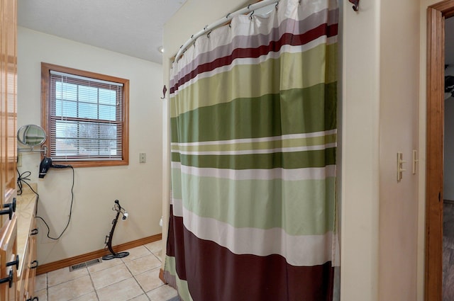 bathroom with visible vents, a shower with shower curtain, a textured ceiling, tile patterned flooring, and baseboards