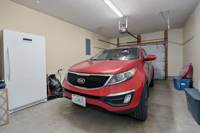 garage with electric panel, freestanding refrigerator, and a garage door opener